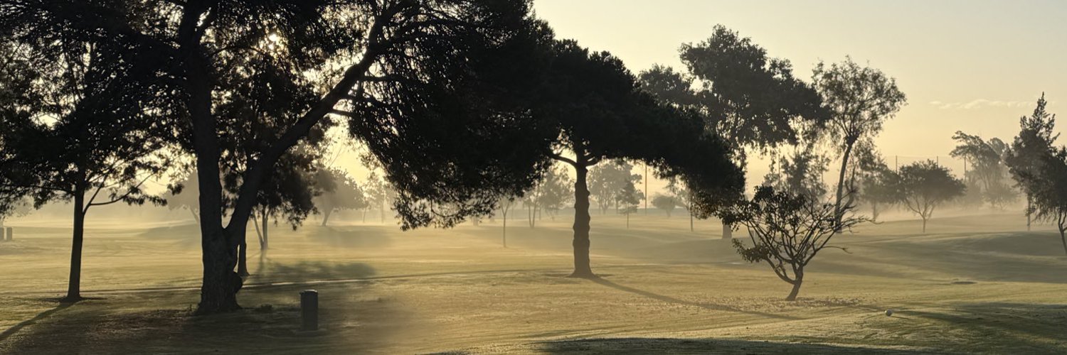 Golden morning light across a golf course
